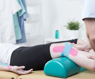 Photo of patient with elastic therapeutic tape during exercises