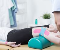Photo of patient with elastic therapeutic tape during exercises